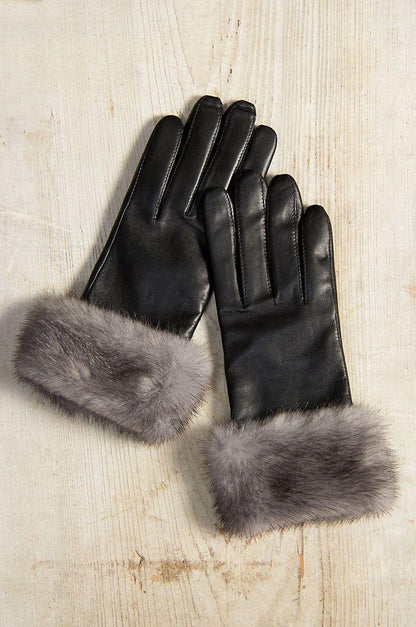 Black leather gloves grey fur cuffs luxury winter close up